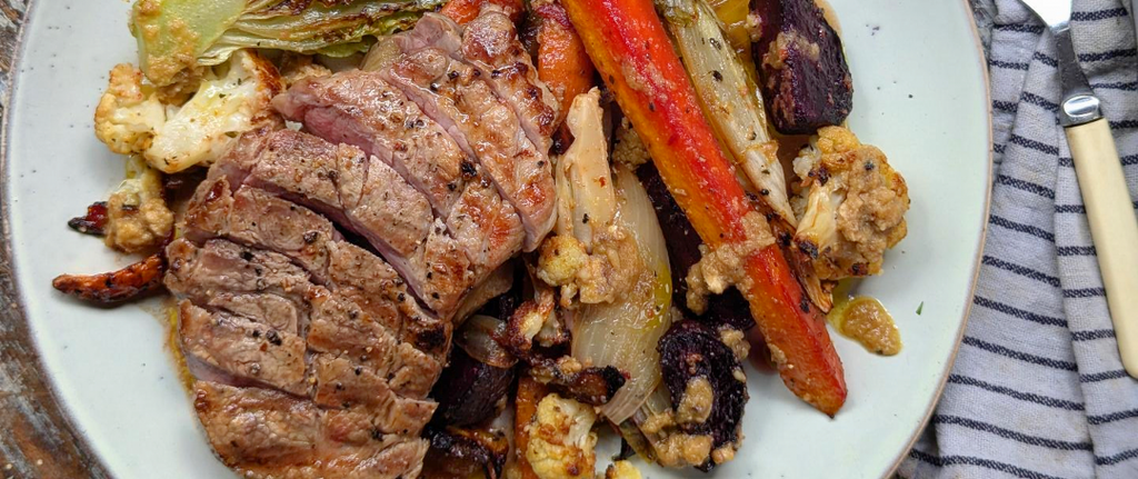 PORK RIB-EYE STEAK WITH ROAST ROOT VEGETABLES AND SALSA BIANCA