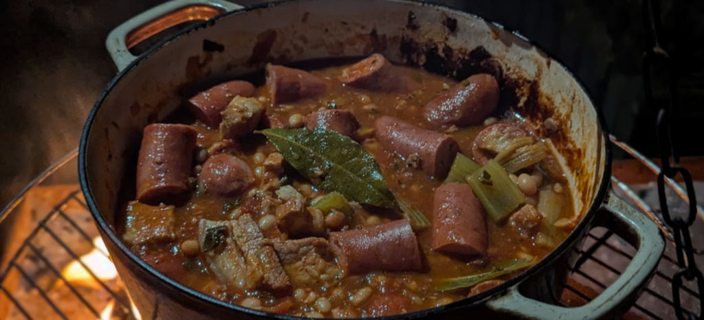 CAMPFIRE STEW WITH BEANS, PORK BELLY AND BUTCHERS DOGS